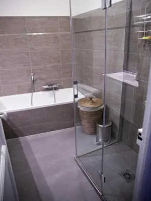 a bathroom with a shower and a tub and a sink at 