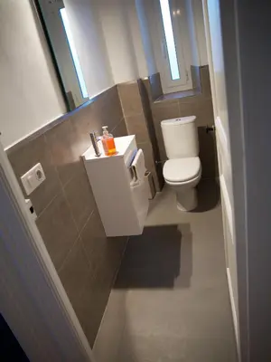a small bathroom with a toilet and a window at 