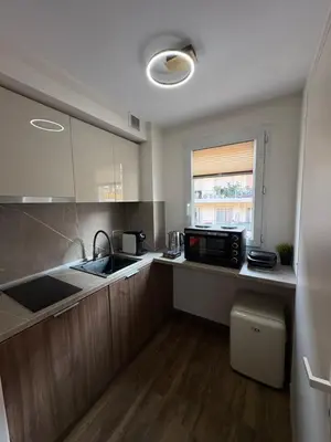 a kitchen with a sink and a microwave at Perle au Port de NICE in Nice