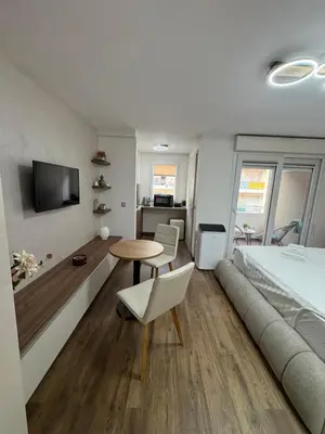 a bedroom with a bed and a table and a couch at Perle au Port de NICE in Nice