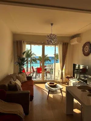 a living room with a view of the ocean at Appartement La Promenade Des Anglais in Nice