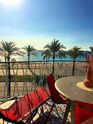 a table and chairs with a view of the beach at Appartement La Promenade Des Anglais in Nice
