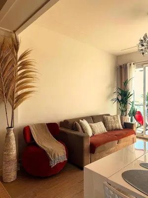 a living room with a couch and a table at Appartement La Promenade Des Anglais in Nice