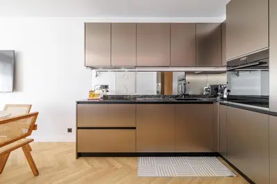 a kitchen with stainless steel appliances and a table at Outstanding View on the Promenade - Awesome 2 Bdr in Nice