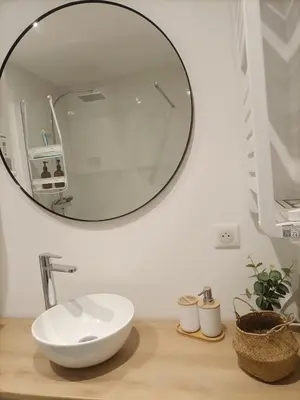 a bathroom with a sink and a mirror on a counter at Apartsuite jardin Nice cap 3000 bord de mer in Saint-Laurent-du-Var