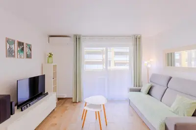 a living room with a couch and a tv at Peaceful apartment in Nice with terrace, parking in Nice