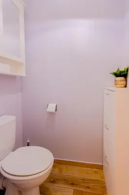 a bathroom with a toilet and a toilet paper dispenser at Peaceful apartment in Nice with terrace, parking in Nice
