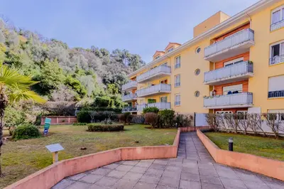 an apartment building with a park in front of it at Peaceful apartment in Nice with terrace, parking in Nice