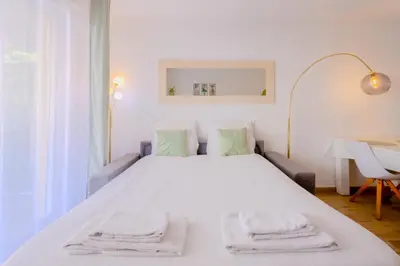 a bedroom with a white bed with towels on it at Peaceful apartment in Nice with terrace, parking in Nice