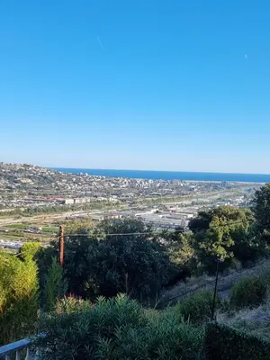 a view of a city from the top of a hill at 2 pièces avec jardin vue mer in Saint-Laurent-du-Var