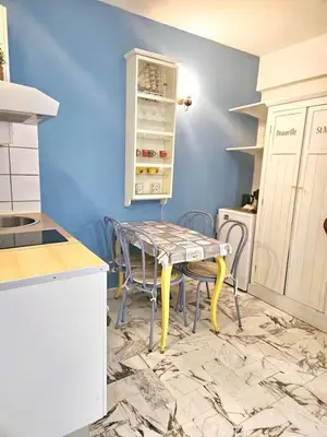 a kitchen with a table and chairs in a room at Nice Studio proche mer in Nice