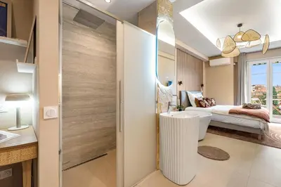 a bathroom with a sliding door leading to a bedroom at Nice Renting - HUGO - Luxury Honeymoon Suite Terrace Park View Free Parking in Nice