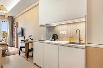 a kitchen with white cabinets and a sink at Nice Renting - HUGO - Luxury Honeymoon Suite Terrace Park View Free Parking in Nice