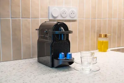 a coffee maker sitting on a kitchen counter with glasses at Nice Renting - HUGO - Luxury Honeymoon Suite Terrace Park View Free Parking in Nice