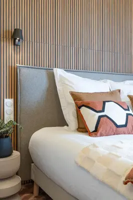 a bed with a pillow on it in a bedroom at Nice Renting - HUGO - Luxury Honeymoon Suite Terrace Park View Free Parking in Nice