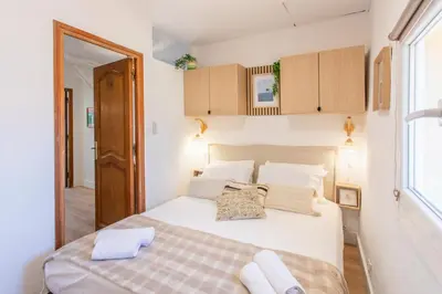 a bedroom with a large white bed and cabinets at #36 Bright Eagle Nest Old town 5 mins from sea AC Wifi in Nice