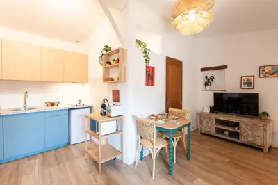 a kitchen and dining room with a table and a counter at #36 Bright Eagle Nest Old town 5 mins from sea AC Wifi in Nice