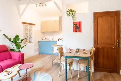 a living room with a red couch and a table at #36 Bright Eagle Nest Old town 5 mins from sea AC Wifi in Nice