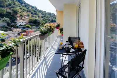 a balcony with a table and chairs with a view at Appartement luxueux entier 3 chambres in Nice