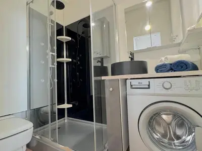 a bathroom with a washing machine and a toilet at ⁂ Petit nid design au centre de Nice in Nice