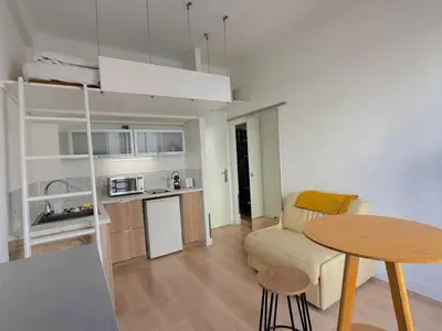 a small living room with a table and a kitchen at ⁂ Petit nid design au centre de Nice in Nice