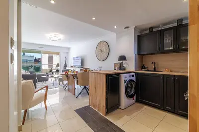 a kitchen and dining room with a washer and dryer at MY CASA - PALAIS MED 702 D - 2 bedroom Down Town with Terasse AC in Nice