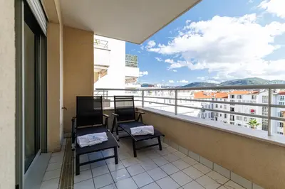 two chairs on a balcony with a view of a building at MY CASA - PALAIS MED 702 D - 2 bedroom Down Town with Terasse AC in Nice