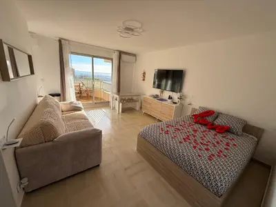 a living room with a bed and a couch at Le Cocon in Nice