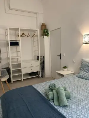 a white bedroom with a bed and a white closet at Élégant T2 au calme in Nice