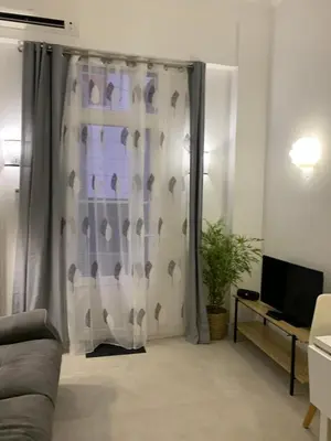 a living room with a shower curtain with birds on it at Élégant T2 au calme in Nice