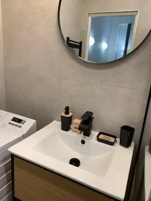 a bathroom with a sink and a mirror at Élégant T2 au calme in Nice
