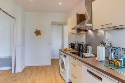 a kitchen with a washing machine and a washer at NID MASSENA AP4486 by RIVIERA HOLIDAY HOMES in Nice