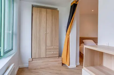 a room with a closet and a bedroom with a bed at NID MASSENA AP4486 by RIVIERA HOLIDAY HOMES in Nice