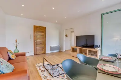 a living room with a couch and a television at NID MASSENA AP4486 by RIVIERA HOLIDAY HOMES in Nice
