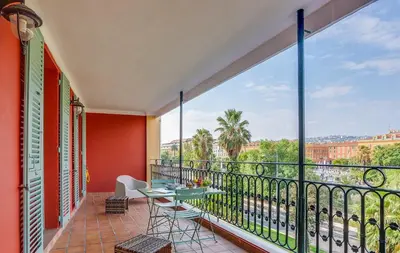 a balcony with a table and chairs and a view at NID MASSENA AP4486 by RIVIERA HOLIDAY HOMES in Nice