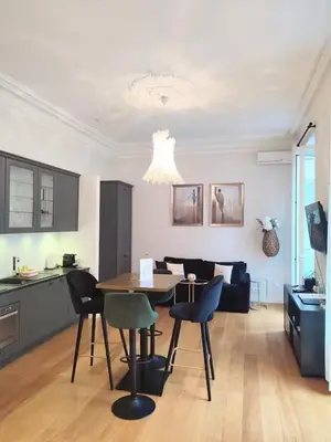 a kitchen and living room with a table and chairs at Studio in the heart of Nice close to amenities in Nice