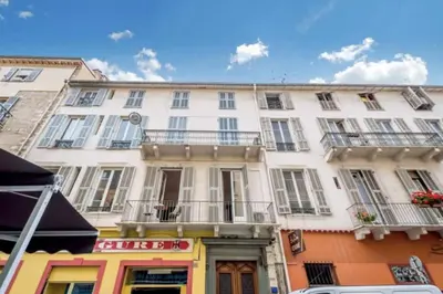a white building with balconies on a city street at Studio in the heart of Nice close to amenities in Nice