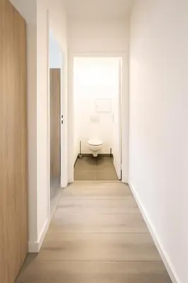 a hallway with a toilet in a white bathroom at Stella Monte 1 AC WiFi 4 Pers in Nice