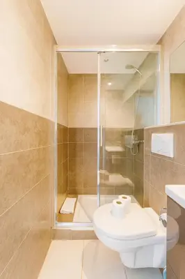 a bathroom with a shower and a toilet and a sink at Le Carré D'or 2 Pers Centrale WiFi AC in Nice