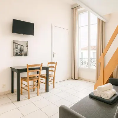 a living room with a dining room table and chairs at Le Carré D'or 2 Pers Centrale WiFi AC in Nice