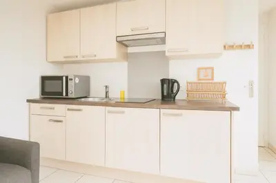a kitchen with white cabinets and a microwave at Le Carré D'or 2 Pers Centrale WiFi AC in Nice