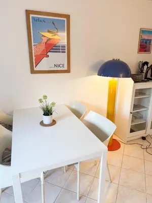 a white table and chairs in a room at Le Soleil D'or 4 Pers Parking WiFi in Nice