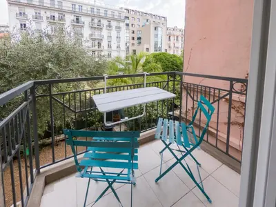 a table and two chairs on a balcony at Le Soleil D'or 4 Pers Parking WiFi in Nice