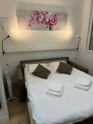 a bed with two towels on top of it at Au cœur du Vieux Nice, superbe studio refait à neuf in Nice