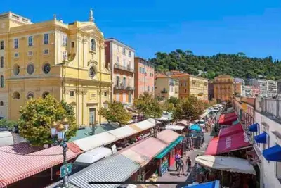a city street with a bunch of shops and buildings at Au cœur du Vieux Nice, superbe studio refait à neuf in Nice