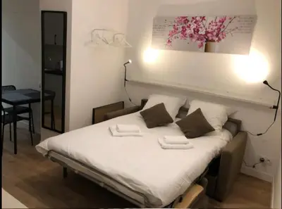 a bed in a room with two towels on it at Au cœur du Vieux Nice, superbe studio refait à neuf in Nice