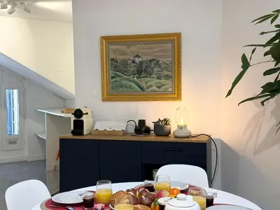 a dining room with a table with food on it at Appartement à 100 m de la mer avec stationnement gratuit in Nice