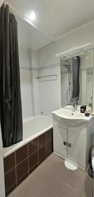 a bathroom with a tub and a sink and a bath tub at Le grand Escurial in Nice