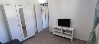 a small room with a television on a small table at chambre en colocation appartement partagé moyenne durée 1 in Nice