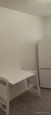 a white table in a room with a refrigerator at chambre en colocation appartement partagé moyenne durée 1 in Nice